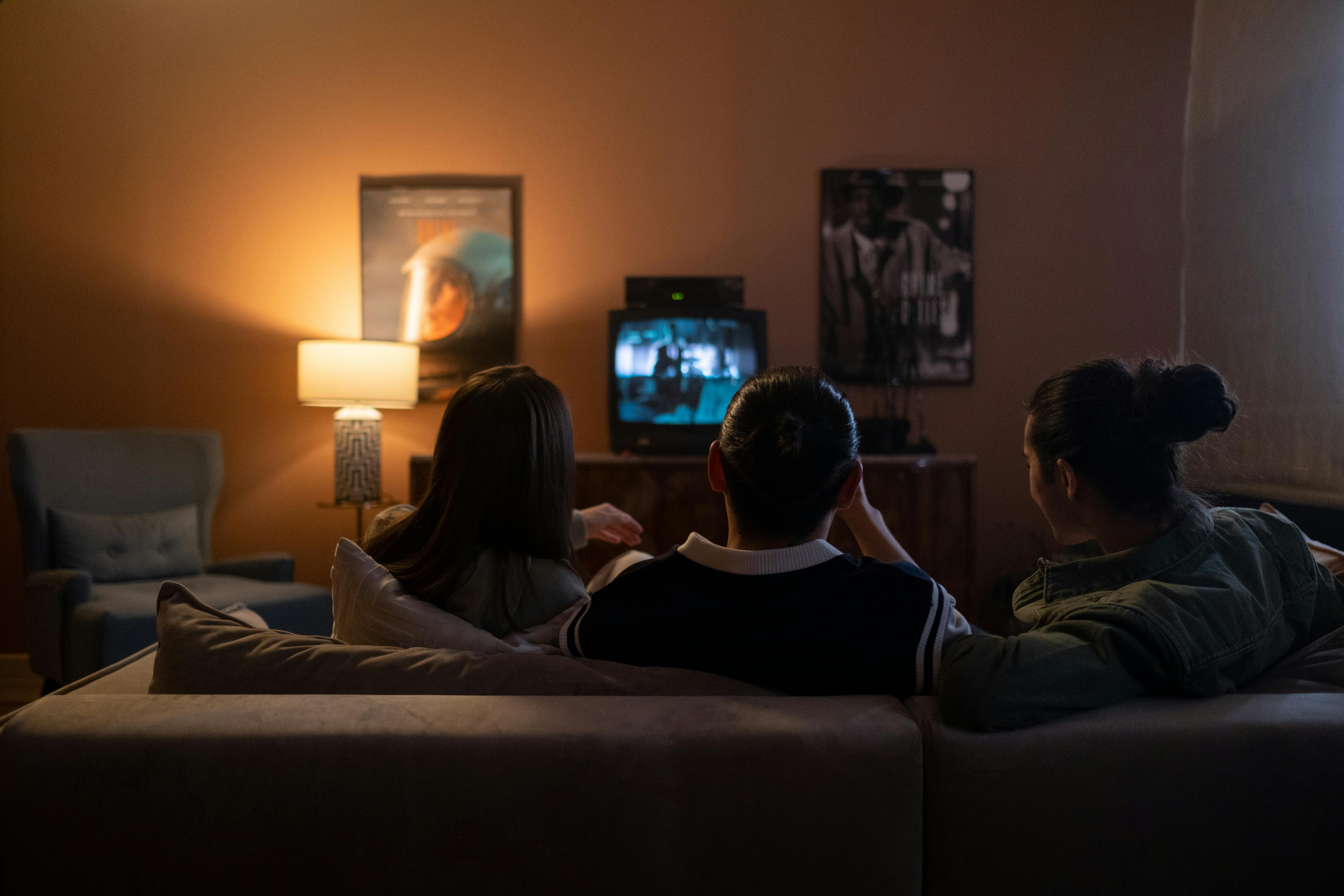 Group watching TV on couch